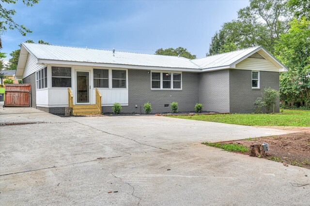 1116 Northwood Rd, Augusta, GA 30909 - view of front of home with entry steps, a metal roof, brick siding, and driveway