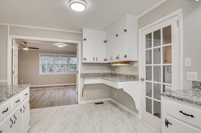 1116 Northwood Rd, Augusta, GA 30909 - kitchen with ornamental molding, white cabinetry, ceiling fan, light stone counters, and light marble finish flooring