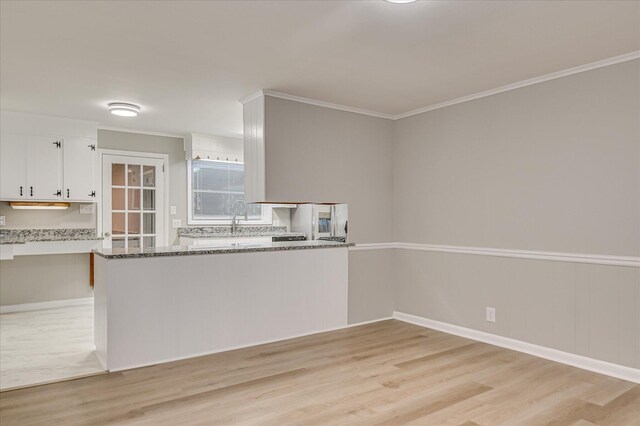 1116 Northwood Rd, Augusta, GA 30909 - kitchen featuring light wood-style flooring, white cabinetry, light stone countertops, and ornamental molding