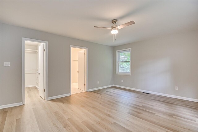 1116 Northwood Rd, Augusta, GA 30909 - unfurnished bedroom with a spacious closet, light wood finished floors, a ceiling fan, connected bathroom, and a closet
