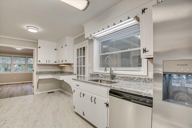1116 Northwood Rd, Augusta, GA 30909 - kitchen featuring stainless steel appliances, white cabinets, light stone countertops, light marble finish flooring, and crown molding