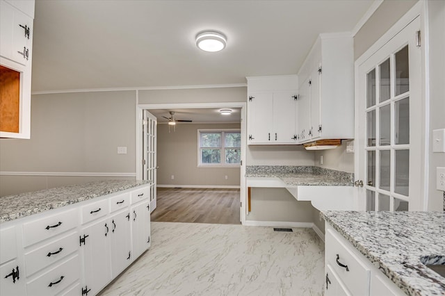 1116 Northwood Rd, Augusta, GA 30909 - kitchen with ceiling fan, white cabinets, crown molding, light stone counters, and light marble finish flooring