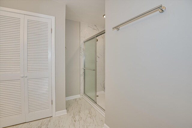 1116 Northwood Rd, Augusta, GA 30909 - bathroom featuring marble look tile flooring, a marble finish shower, and a closet
