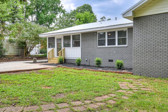 1116 Northwood Rd, Augusta, GA 30909 - view of front of home featuring entry steps, crawl space, brick siding, a patio, and a metal roof