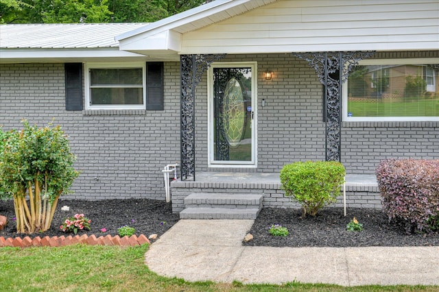 1116 Northwood Rd, Augusta, GA 30909 - view of exterior entry with covered porch, a metal roof, and brick siding