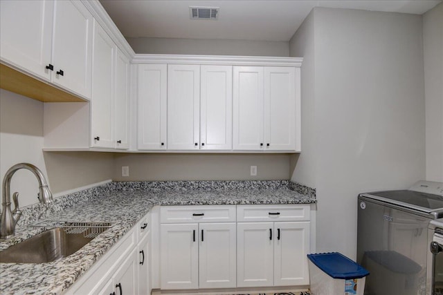 laundry area with sink and cabinets