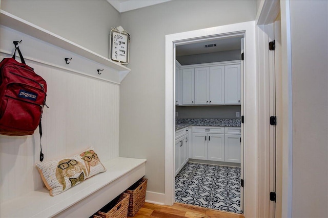 mudroom with light hardwood / wood-style flooring