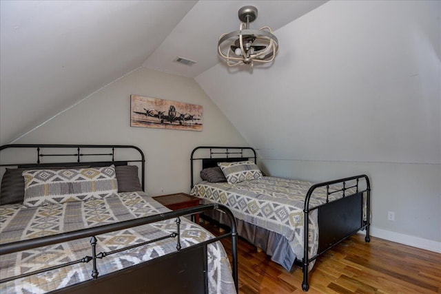 bedroom featuring hardwood / wood-style floors and lofted ceiling