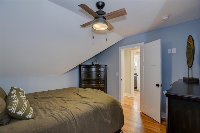 bedroom with ceiling fan, light hardwood / wood-style floors, and lofted ceiling