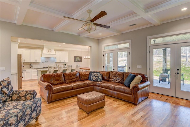 living room featuring light hardwood / wood-style flooring, beam ceiling, and french doors