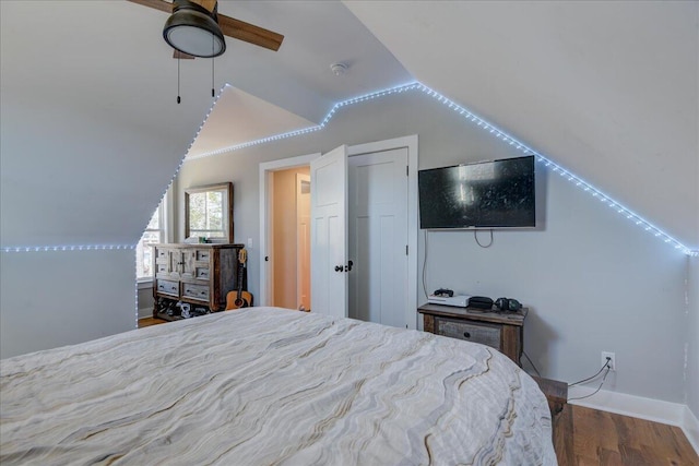 bedroom with vaulted ceiling, ceiling fan, and wood-type flooring