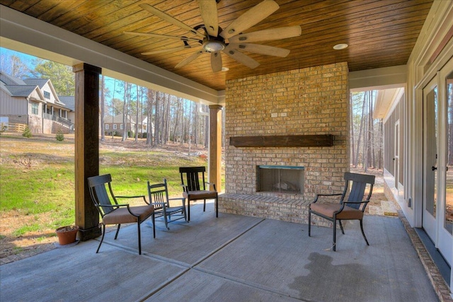 view of patio / terrace featuring an outdoor brick fireplace and ceiling fan