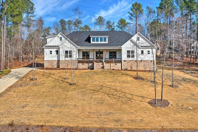 view of front of home with covered porch and a front yard