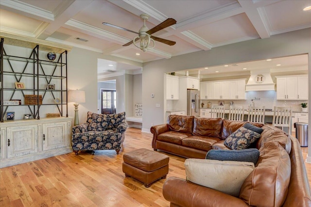 living room featuring ornamental molding, coffered ceiling, beamed ceiling, and light hardwood / wood-style flooring