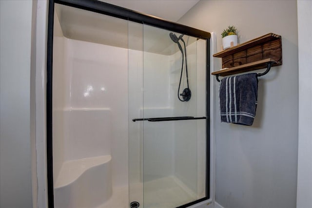 bathroom featuring a shower with door