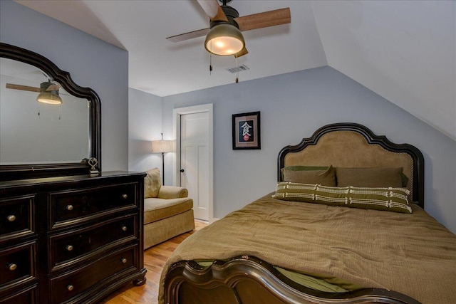 bedroom featuring ceiling fan, vaulted ceiling, and light wood-type flooring