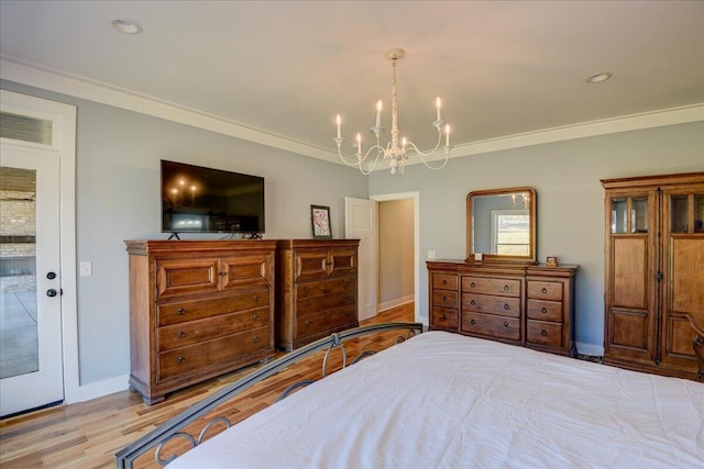 bedroom featuring access to exterior, light hardwood / wood-style flooring, ornamental molding, and a chandelier