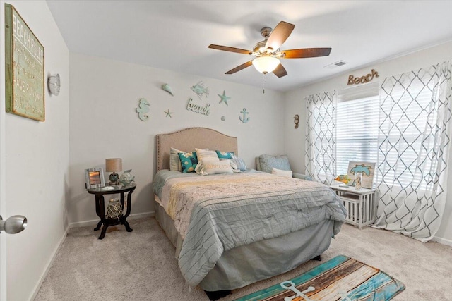 bedroom with ceiling fan and light carpet