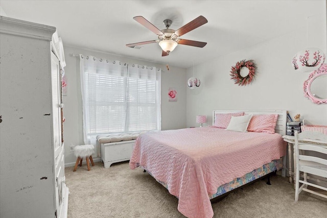 bedroom with ceiling fan and light carpet