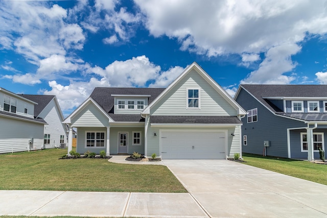 view of front of home with a garage and a front lawn