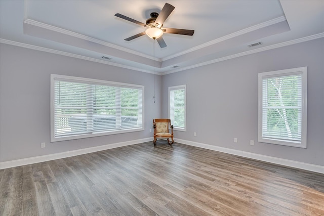 170 Grandview Dr, Mccormick, SC 29835 - unfurnished room with a raised ceiling, plenty of natural light, wood finished floors, a ceiling fan, and ornamental molding