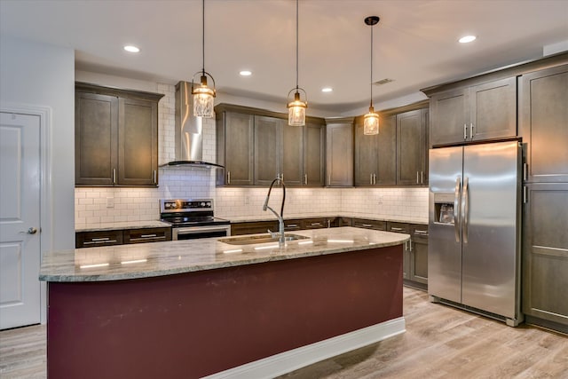 170 Grandview Dr, Mccormick, SC 29835 - kitchen featuring appliances with stainless steel finishes, wall chimney range hood, a sink, light wood-style floors, and recessed lighting