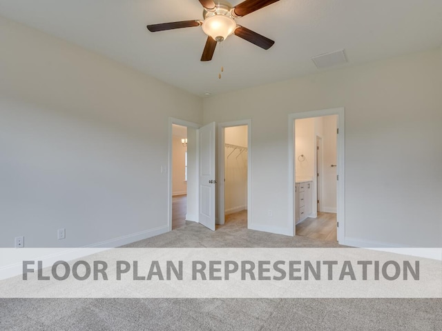 unfurnished bedroom featuring ceiling fan, light colored carpet, a closet, and a walk in closet