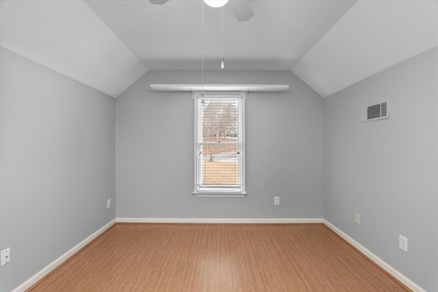 bonus room featuring ceiling fan, lofted ceiling, wood-type flooring, and a textured ceiling