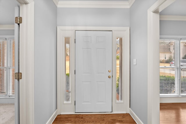 entrance foyer with hardwood / wood-style flooring and ornamental molding