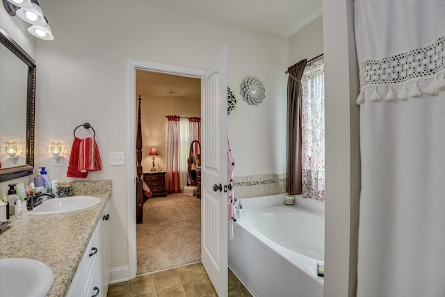 bathroom with a washtub and vanity