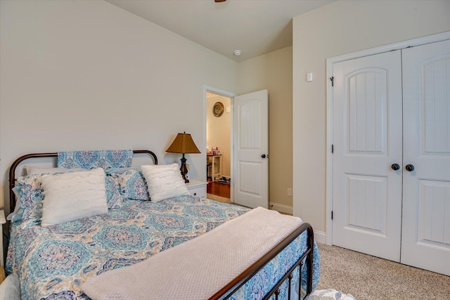 bedroom with light carpet and a closet