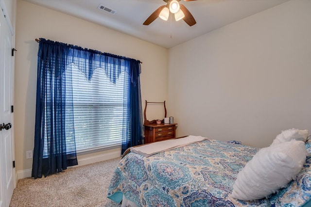 bedroom with ceiling fan and light carpet