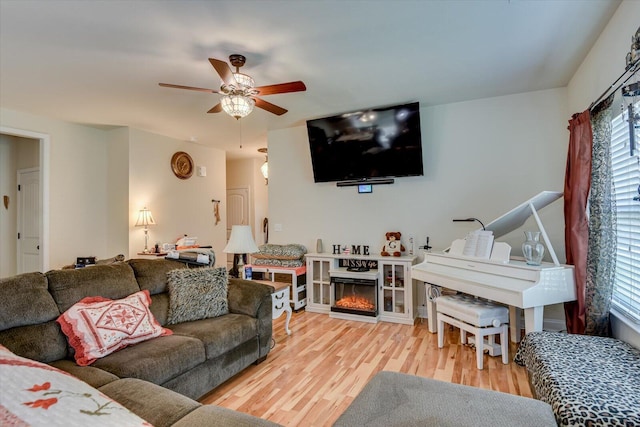 living room with hardwood / wood-style floors, a wealth of natural light, and ceiling fan