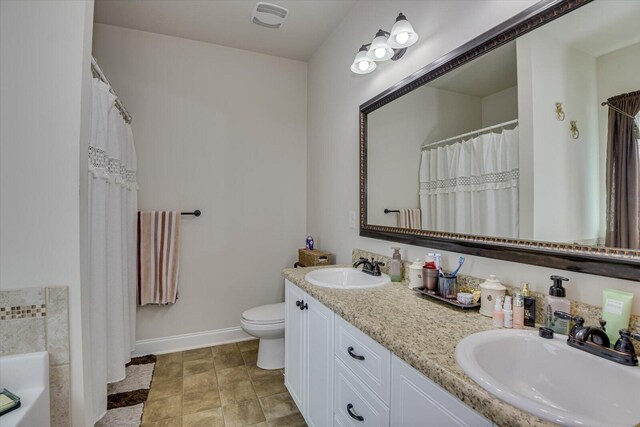 bathroom with vanity, toilet, and a washtub