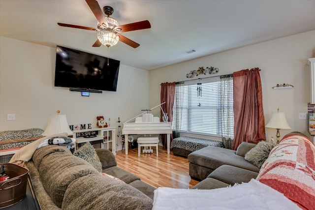 living room with ceiling fan and hardwood / wood-style flooring