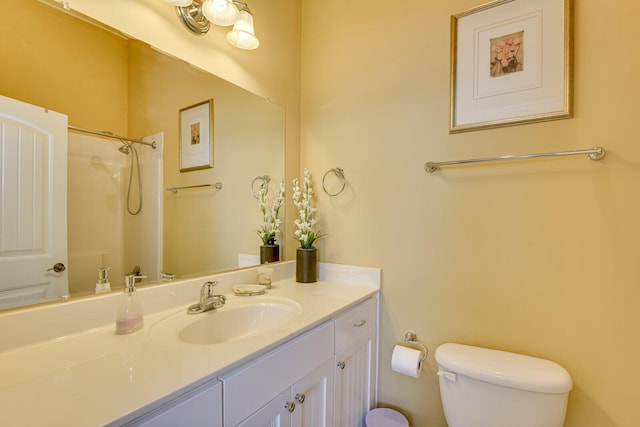 bathroom with toilet, walk in shower, and vanity