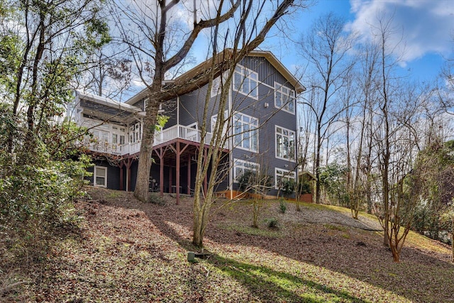 back of property featuring a wooden deck