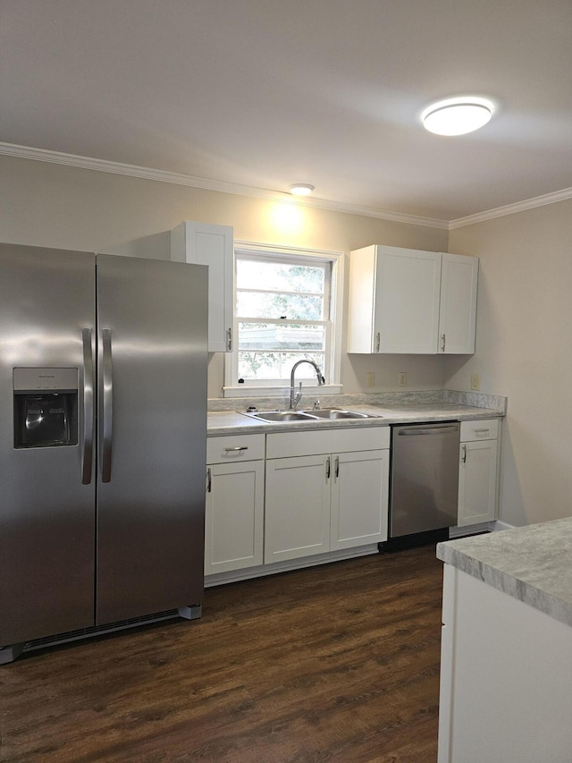 1014 Walnut St, Louisville, GA 30434 - kitchen featuring a sink, white cabinets, light countertops, ornamental molding, and appliances with stainless steel finishes