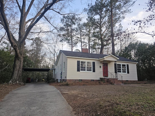 1014 Walnut St, Louisville, GA 30434 - view of front of home featuring crawl space, driveway, a chimney, and a carport