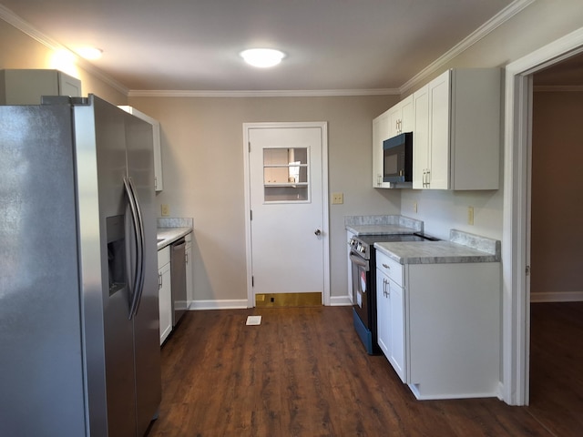 1014 Walnut St, Louisville, GA 30434 - kitchen with stainless steel appliances, light countertops, ornamental molding, and white cabinetry