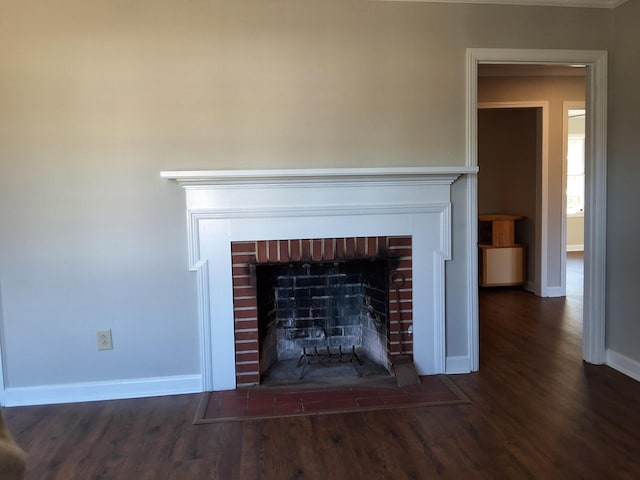 1014 Walnut St, Louisville, GA 30434 - details featuring a brick fireplace, baseboards, and wood finished floors
