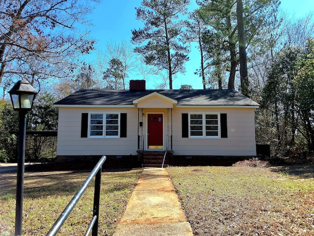 1014 Walnut St, Louisville, GA 30434 - view of front facade featuring a front lawn, crawl space, and a chimney