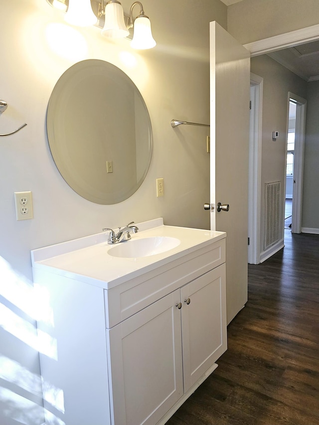 1014 Walnut St, Louisville, GA 30434 - bathroom with a notable chandelier, wood finished floors, and vanity