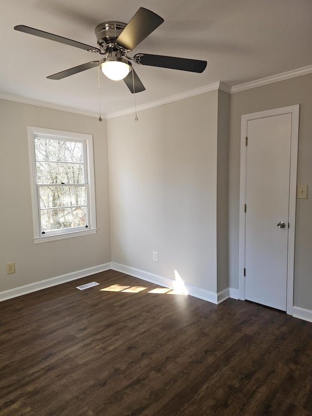 1014 Walnut St, Louisville, GA 30434 - empty room with dark wood finished floors, visible vents, ornamental molding, a ceiling fan, and baseboards