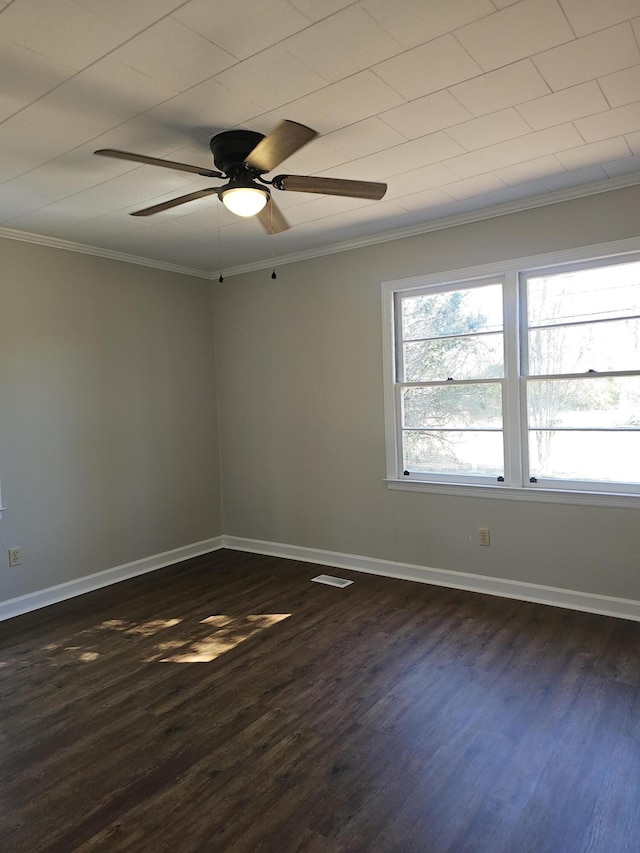 1014 Walnut St, Louisville, GA 30434 - empty room with dark wood-style flooring, visible vents, ornamental molding, a ceiling fan, and baseboards
