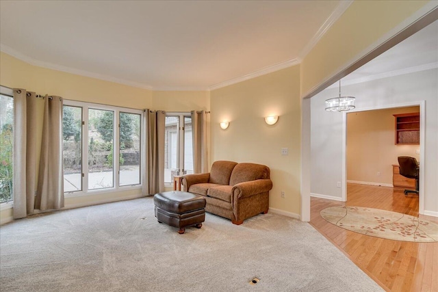 living room with hardwood / wood-style flooring, a chandelier, and ornamental molding