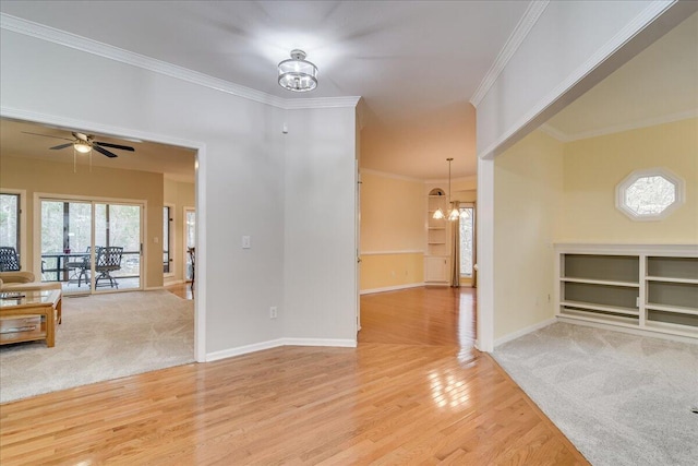 unfurnished room featuring ceiling fan with notable chandelier, light hardwood / wood-style floors, and ornamental molding