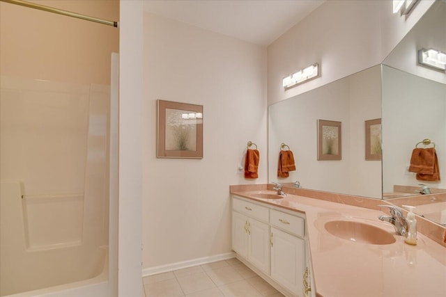 bathroom featuring tile patterned floors, vanity, and walk in shower