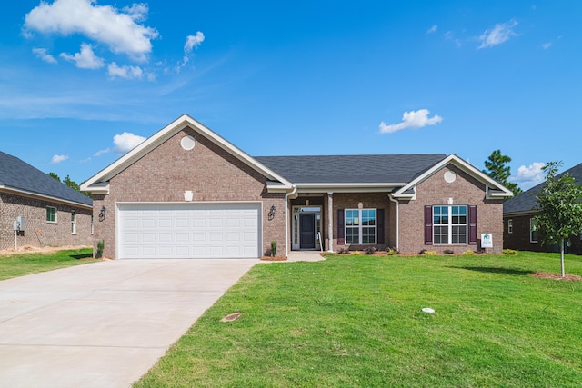 single story home with a garage and a front lawn