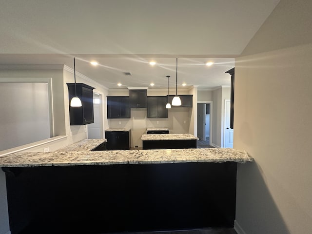 kitchen with crown molding, hanging light fixtures, light stone counters, a kitchen bar, and kitchen peninsula